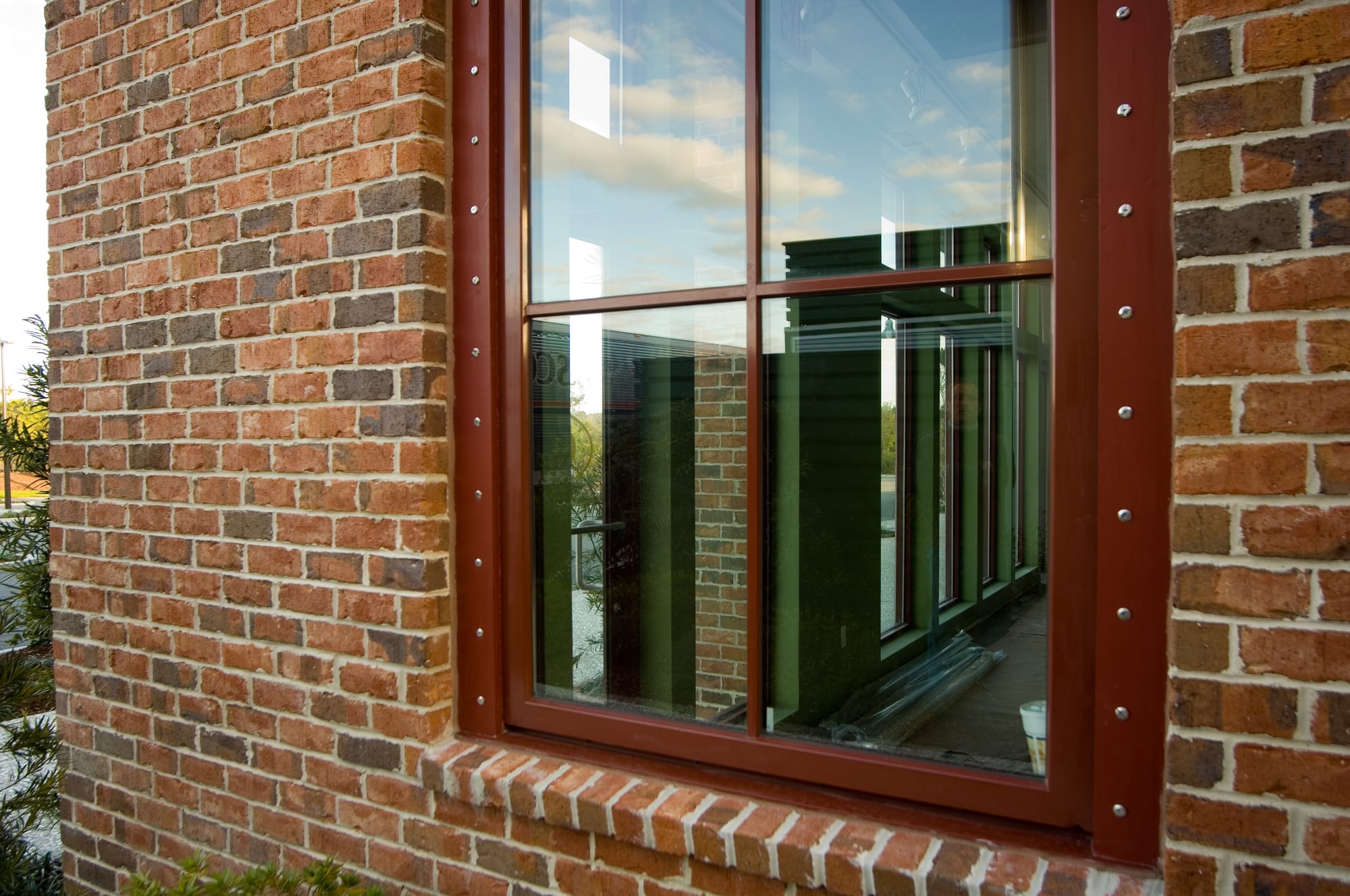 Metal-clad window in brick